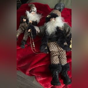 A pair of black and gold luxury dressed Santa’s